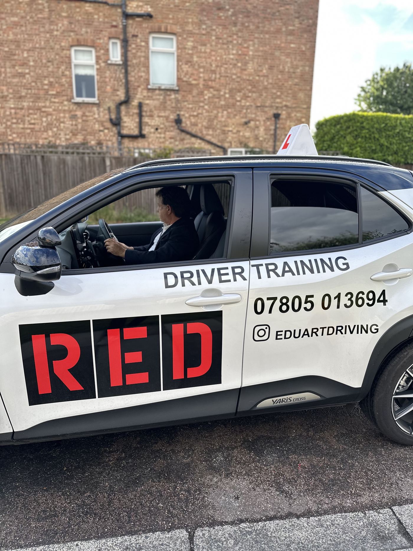 Eduart Driving's branded automatic driving school car in Barnes — contact 07805 013694 or @eduartdriving on Instagram
